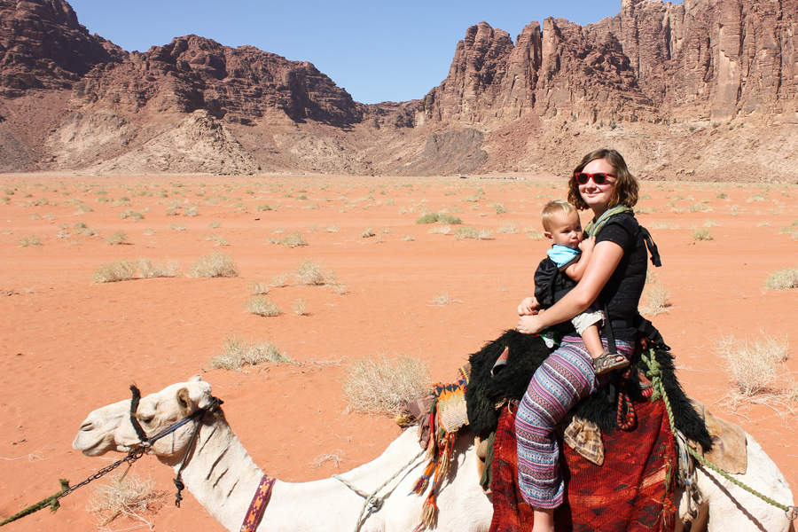 Toddler riding a camel, Jordan