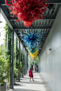 woman walking through Chihuly gallery